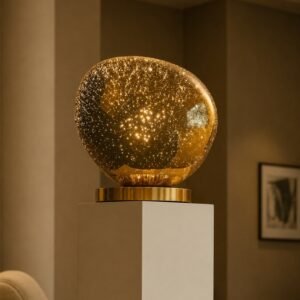 Luxury amber glass orb sculpture with celestial sparkling details on a premium metallic base.