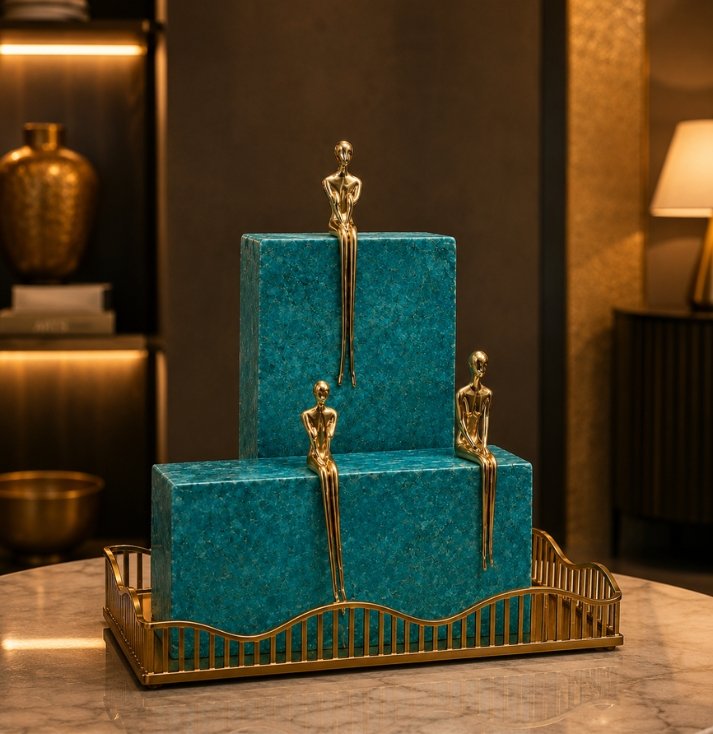 Harmony Figurine Sculpture Set – Luxury Modern Table Décor Luxury decorative sculpture set featuring three gold-tone minimalist figurines seated on crystal-inspired blocks displayed on a decorative tray.