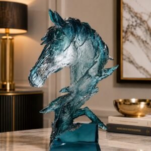 Blue crystal-inspired horse head sculpture with flowing artistic details displayed on a tabletop in a luxury modern interior setting.