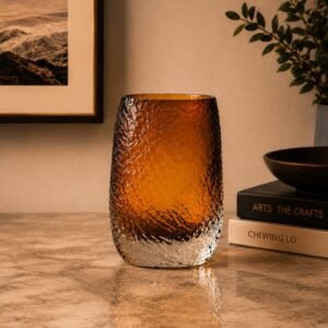 Luxury amber textured glass vase with a gradient finish transitioning into a clear crystal base, displayed as an elegant decorative accent in a sophisticated modern interior.