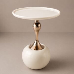 Luxury ivory side table with round tabletop, polished gold pedestal, and sculptural spherical base.