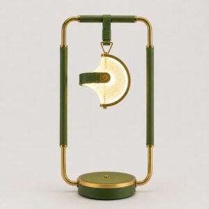 Luxury designer table lamp with a suspended illuminated shade, gold metal frame, and green leather accents, creating a sophisticated statement lighting piece for modern interiors.
