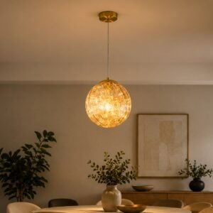 Luxury crystal globe pendant light with a sparkling illuminated shade and gold ceiling mount, suspended above a dining space in a sophisticated contemporary interior.