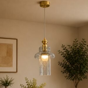 Luxury seeded glass pendant light with a layered transparent glass shade, brushed gold accents, and warm ambient illumination, suspended in a sophisticated contemporary interior.