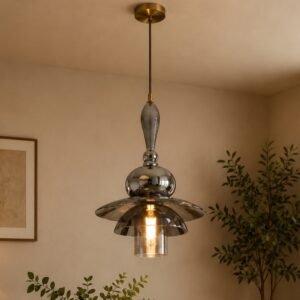 Luxury smoked glass pendant light with layered sculptural glass elements, polished metallic accents, and warm ambient illumination, suspended in a sophisticated contemporary interior.