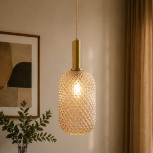 Luxury champagne crystal pendant light with a diamond-cut textured glass shade, brushed gold accents, and warm ambient illumination, suspended in a sophisticated contemporary interior.