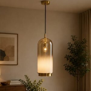 luxury fluted glass pendant light with a cylindrical ribbed glass shade, gradient finish, brushed gold accents, and warm ambient illumination in a sophisticated modern interior.