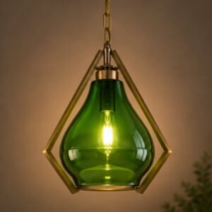 Luxury emerald green glass pendant light with geometric brass frame and warm ambient glow.