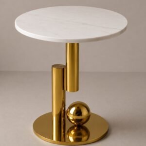 Luxury white marble accent table with a sculptural gold metal base featuring geometric cylindrical elements and a polished gold sphere, designed for modern and contemporary interiors.
